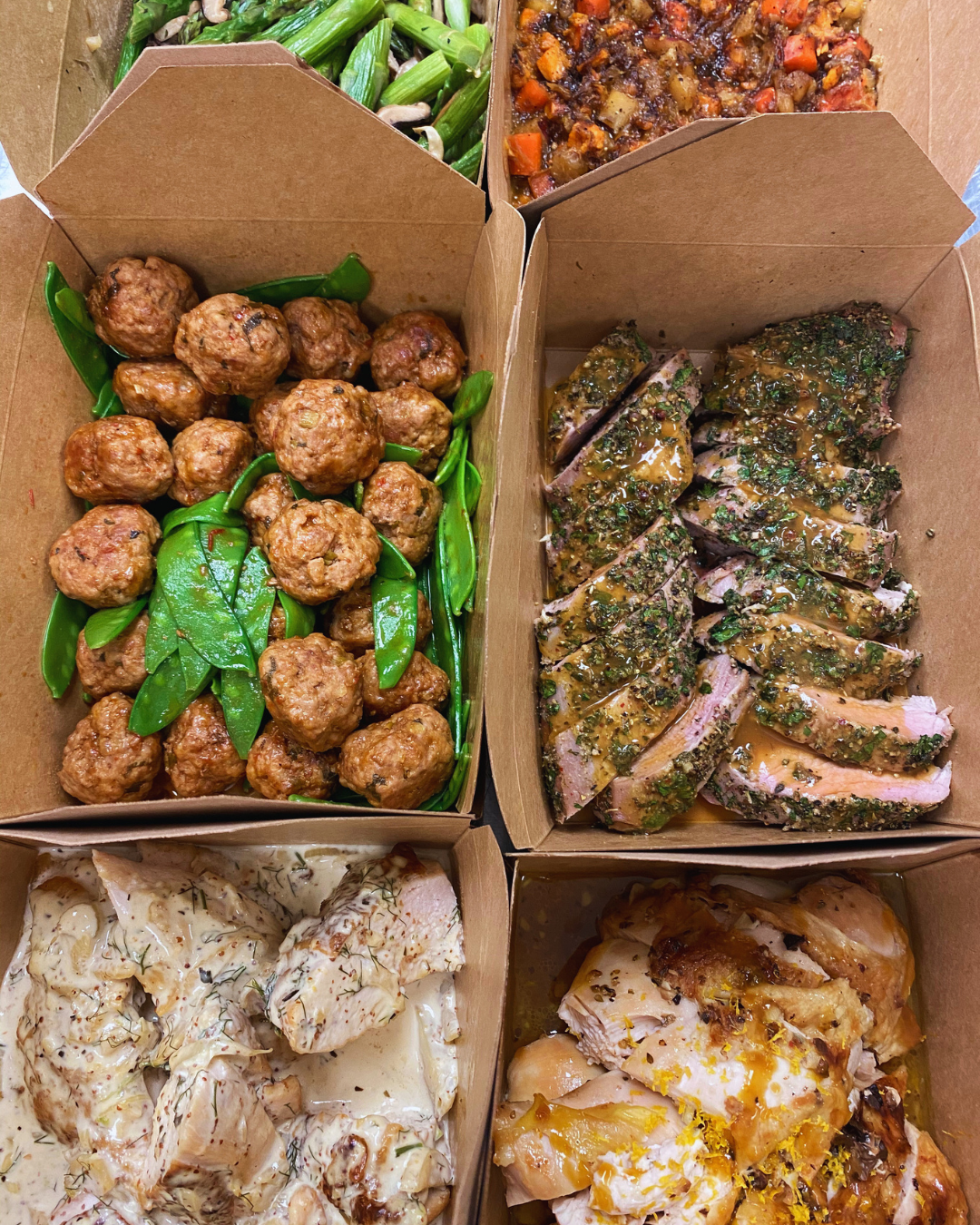 Weekly meal prep boxes with meatballs, herb-crusted pork, and roasted vegetables